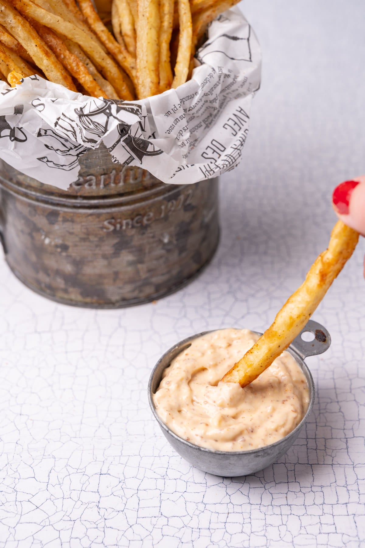 Dipping a hand cut French fry into Cajun Remoulade.