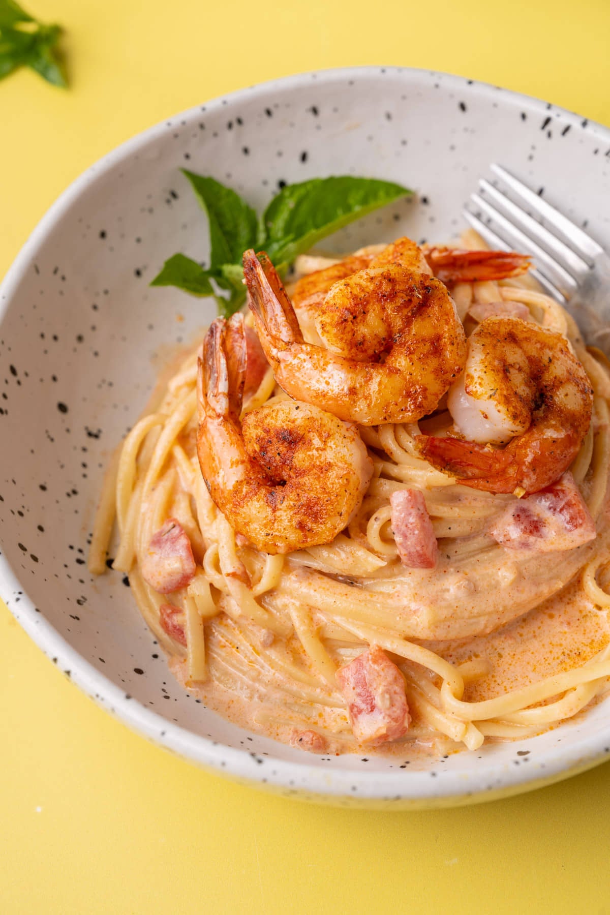 Close up of creamy Cajun shrimp pasta cropped with fork in it.