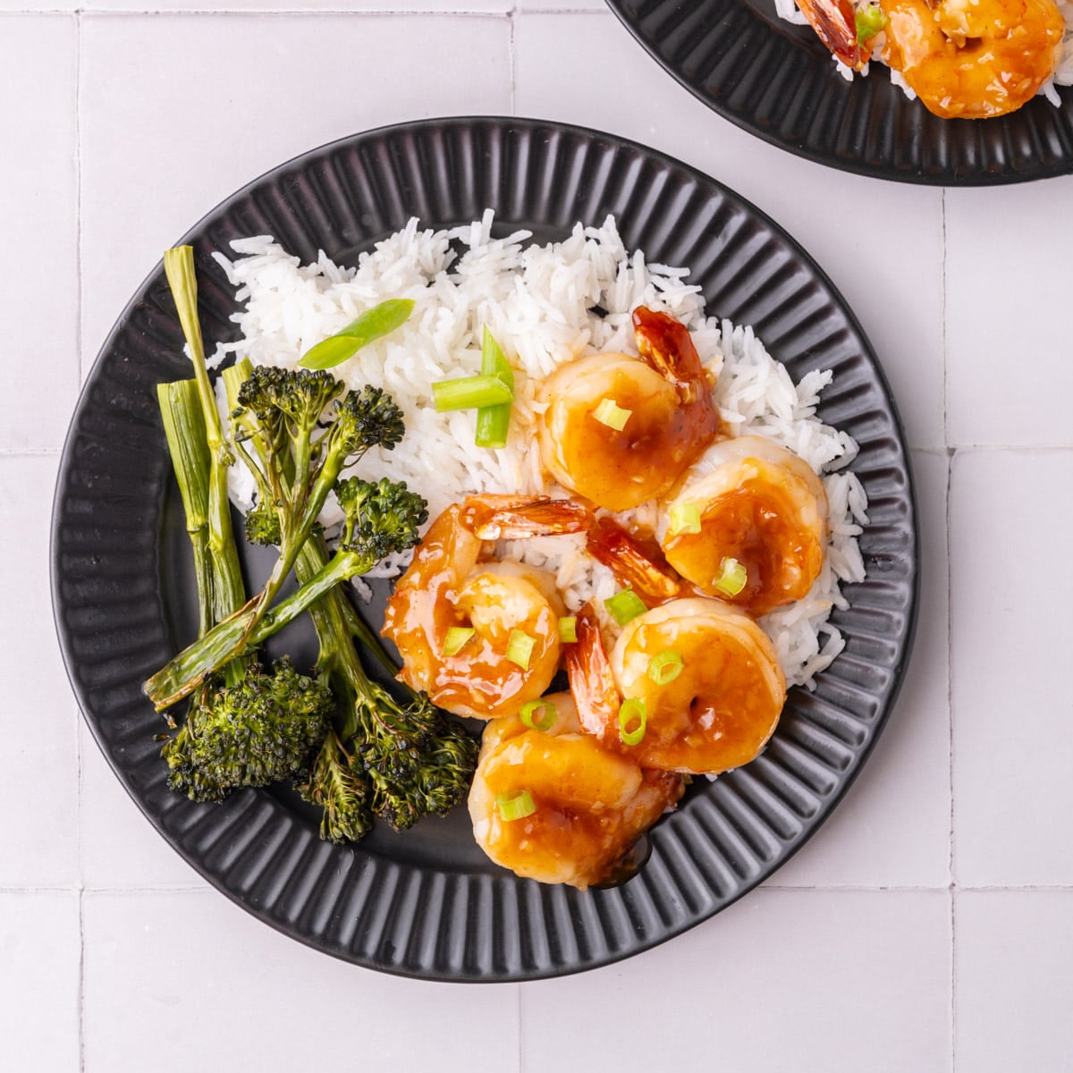 Honey Garlic Shrimp plated with white rice and roasted broccolini.