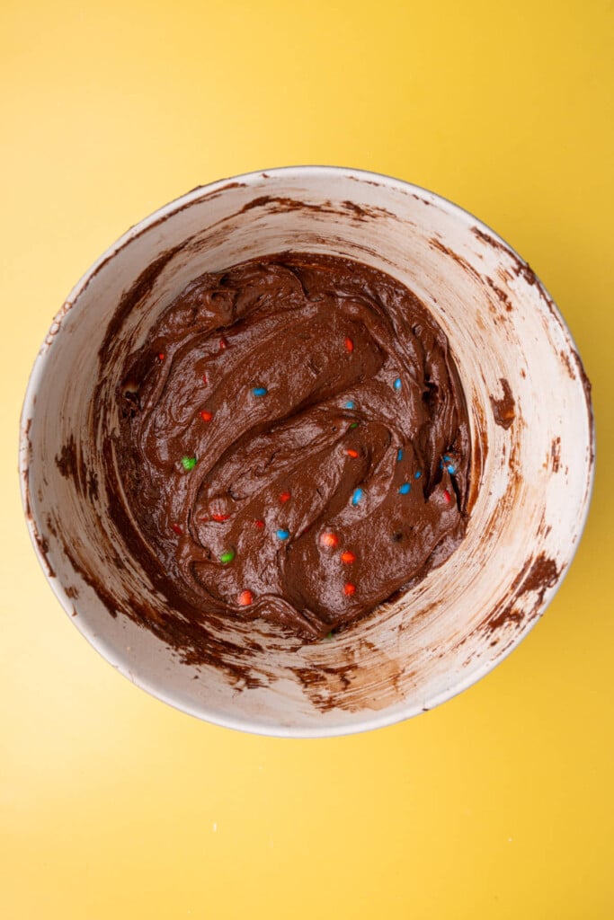 Chocolate brownie batter with colorful M&M's mixed in. 