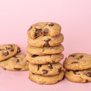 Chocolate chip cookies made with olive oil stacked on top of one another.