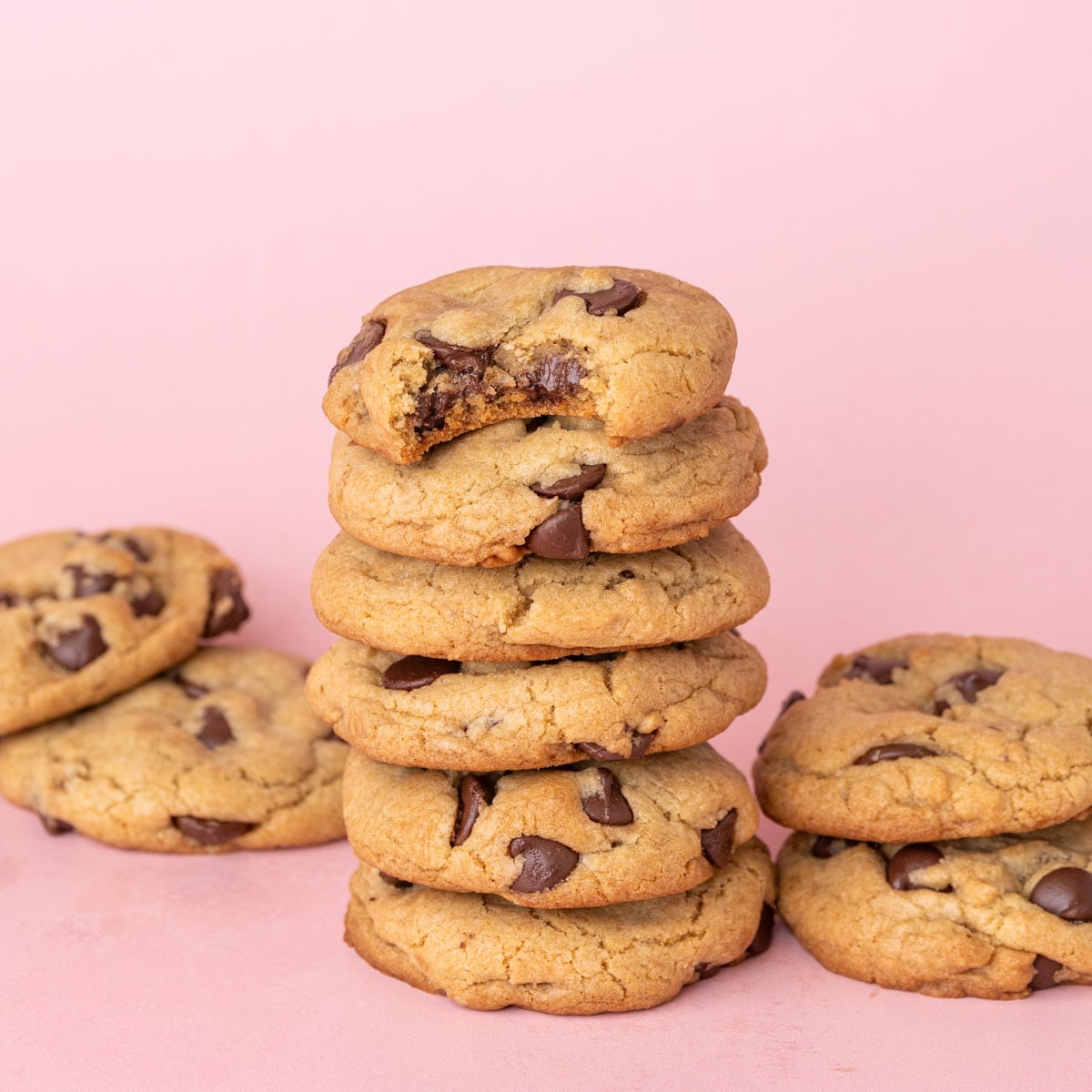 Chocolate chip cookies made with olive oil stacked on top of one another.