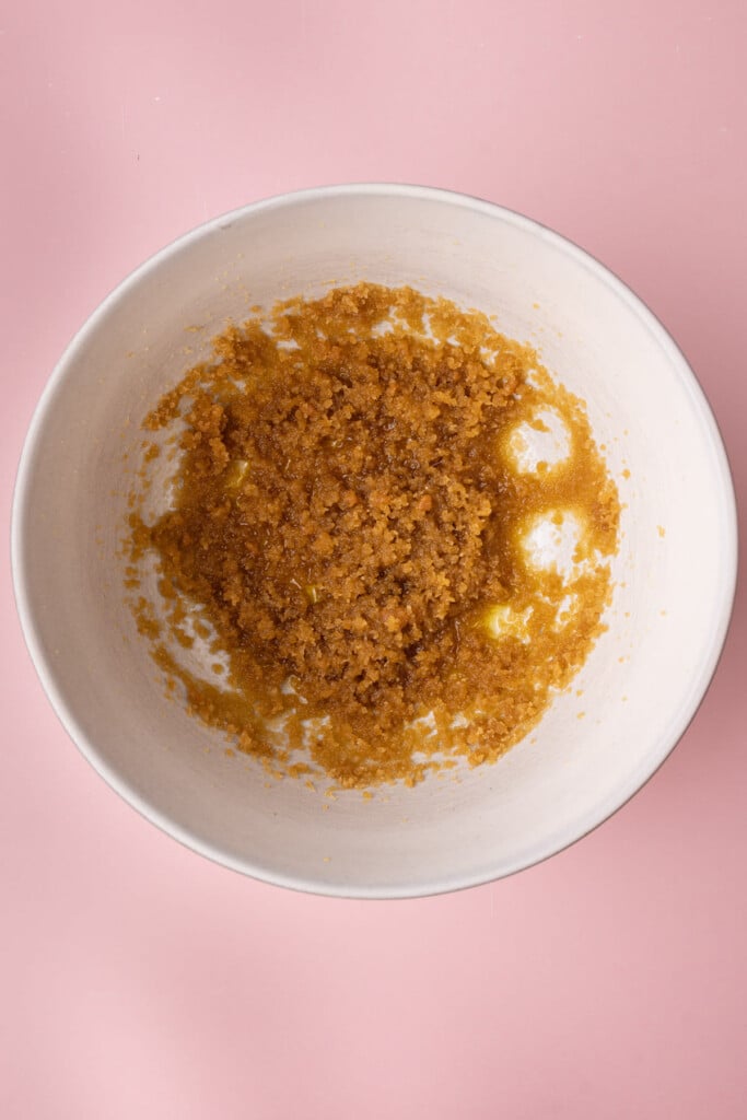 Large mixing bowl with olive oil and brown sugar creamed together for an olive oil-based cookie dough.