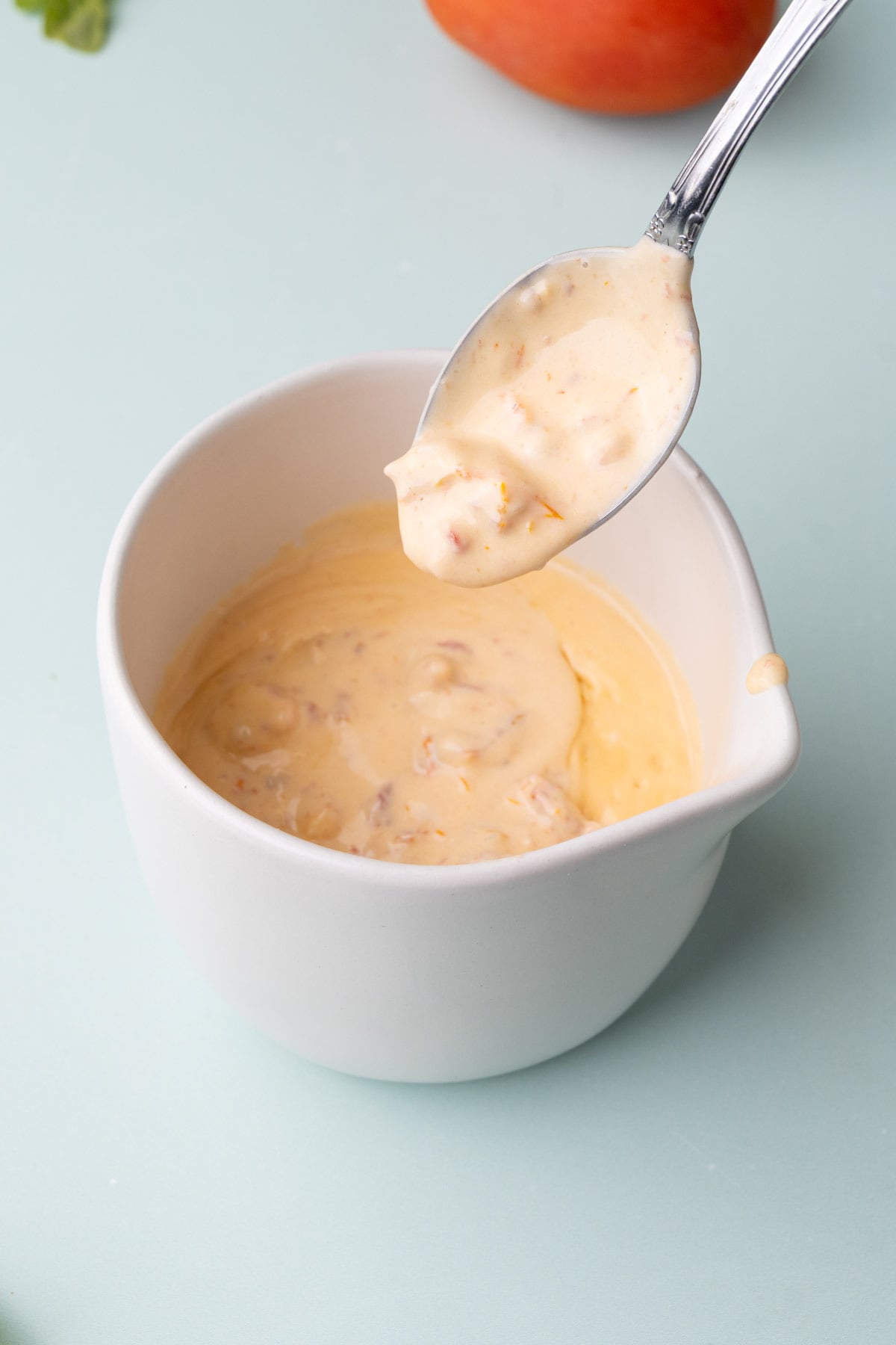 Sun-dried tomato cream sauce on a spoon.