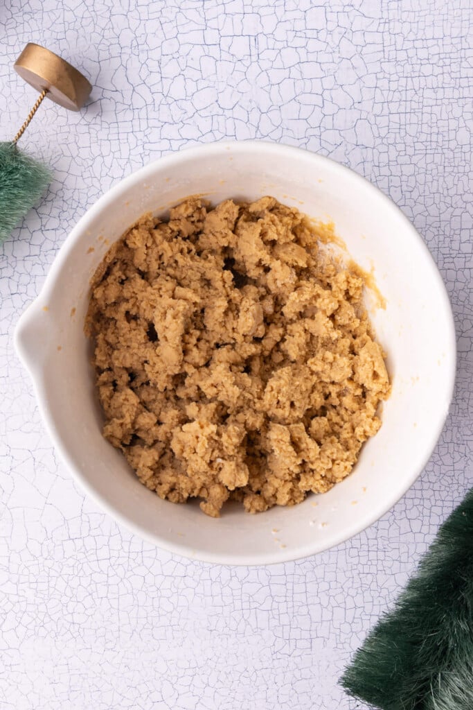 Christmas cookie dough with a brown sugar base, mixed together in a bowl.