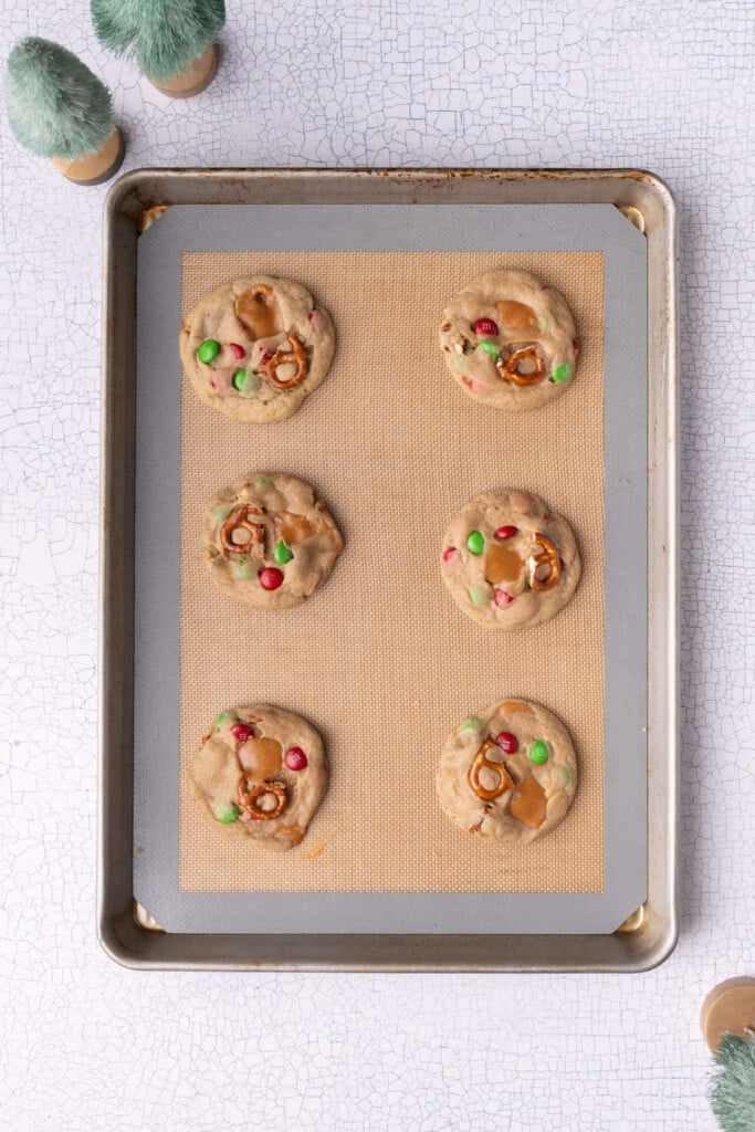 Freshly baked everything but the kitchen sink cookies with green and red M&M's to make them festive for Christmas.