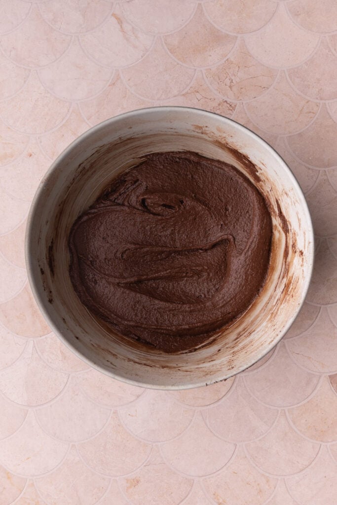 Thick brownie batter in a mixing bowl.