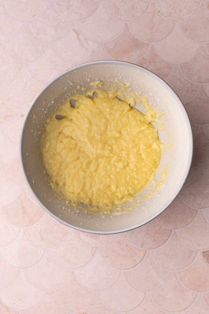 Butter, oil, sugar, eggs, and vanilla extract mixed together to form the base of a homemade brownie batter.