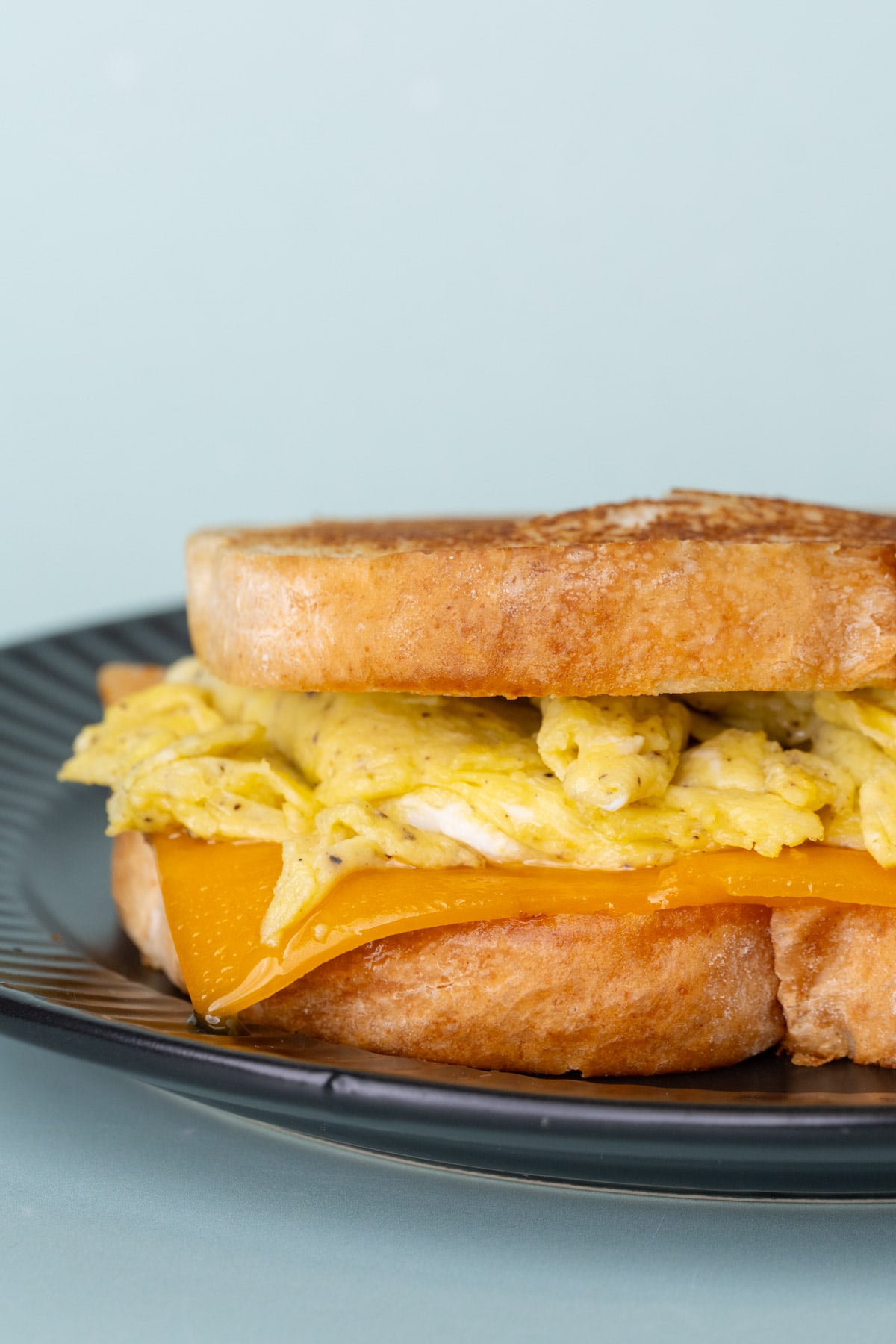 Pan-toasted scrambled egg sandwich with melted cheddar cheese.