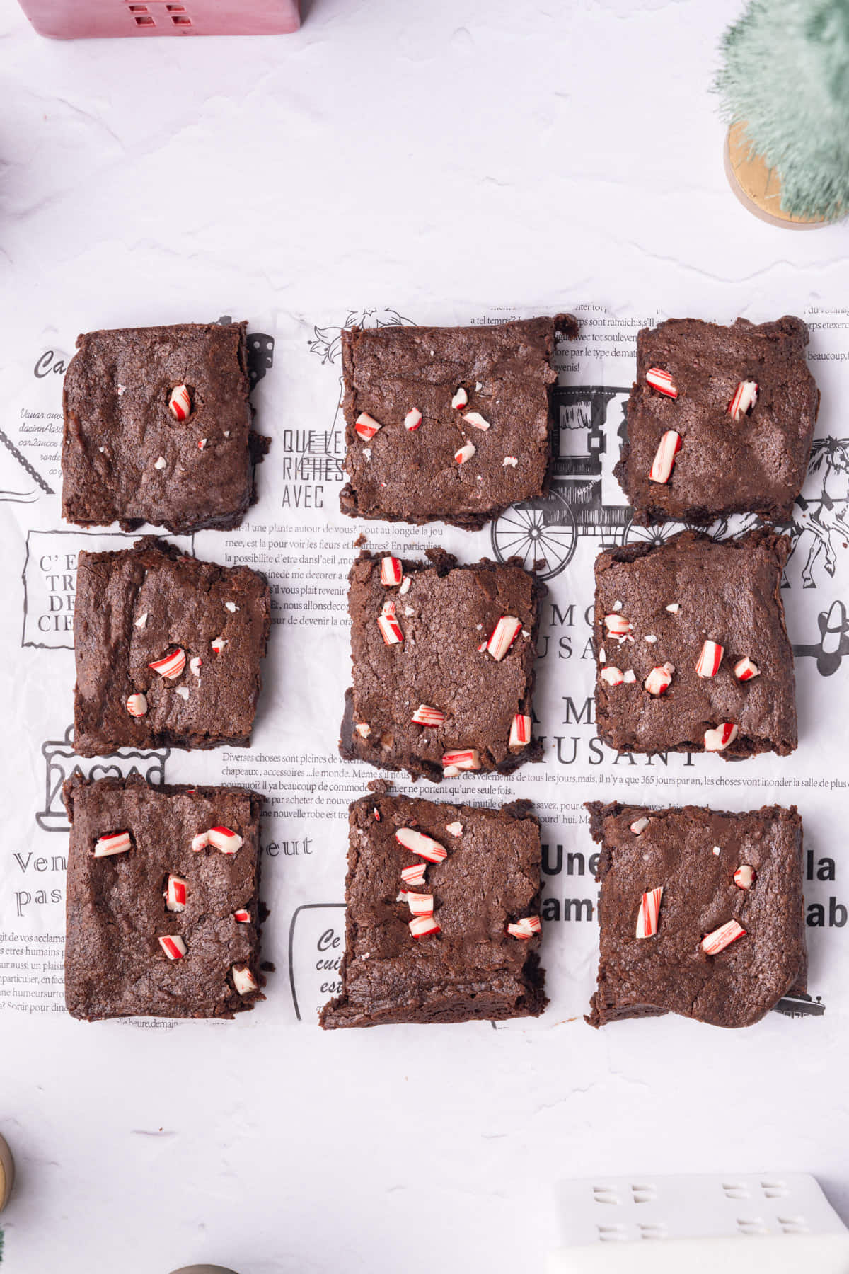 9 large brownies with crushed candy cane on top.