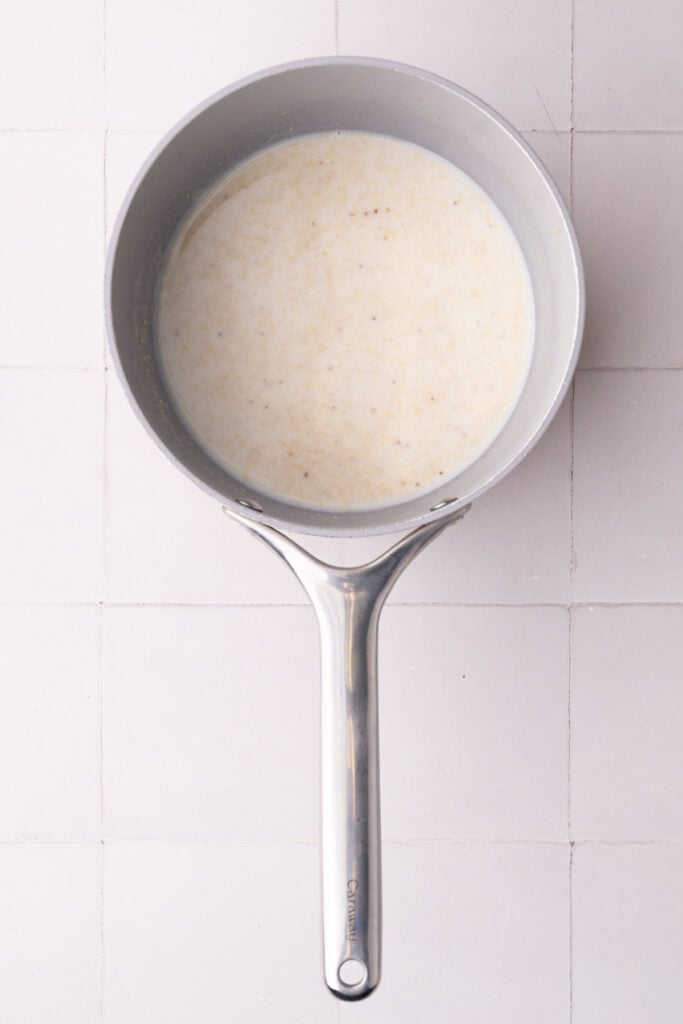 Milk added to a pot with a roux to thicken on the stove as the base for a pretzel dipping sauce.