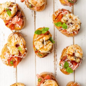 Bruschetta with baked shrimp on top.