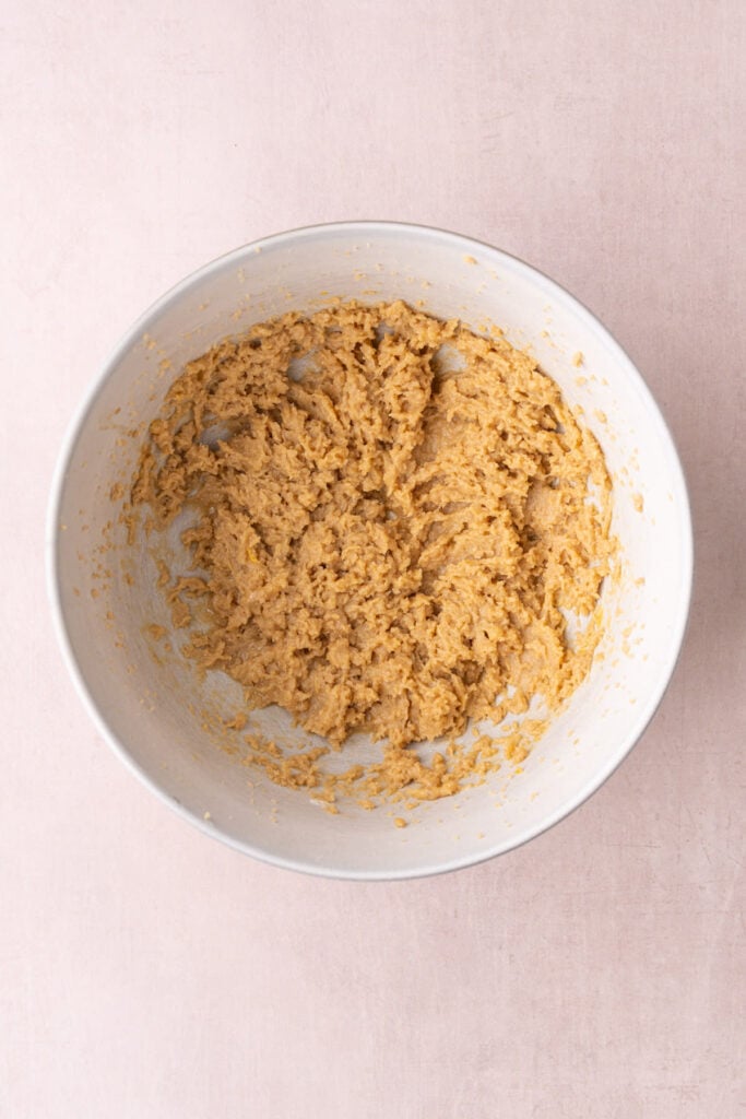 Butter, brown sugar, egg, and vanilla extract whipped together to form an airy base for homemade cookie dough.