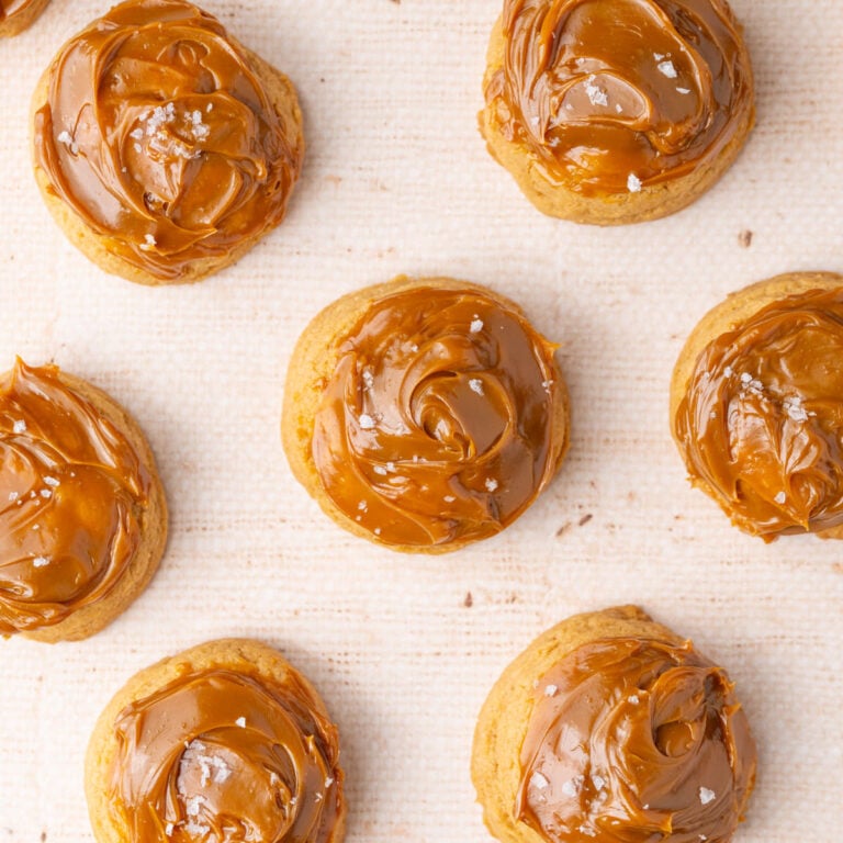 Overhead image of cookies made with dulce de leche both in the dough and spread on top.