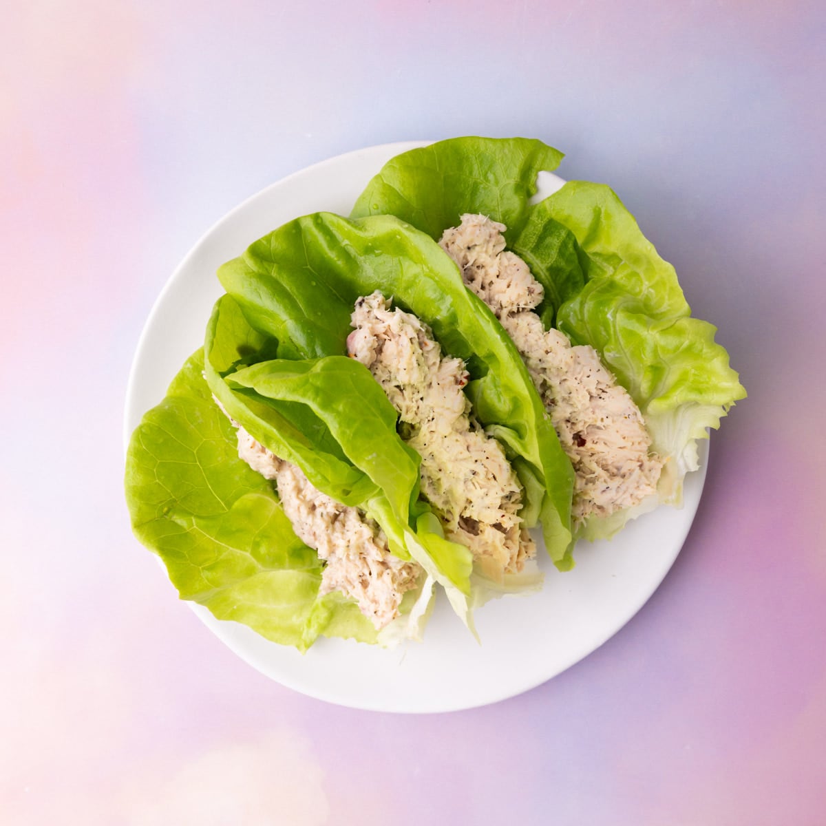 3 lettuce wraps stuffed with prepared canned tuna fish.