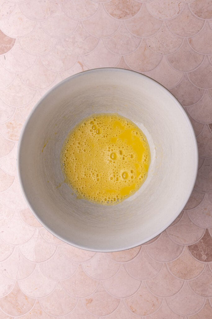 Eggs beaten together in a large mixing bowl; starting a coffee cake batter.