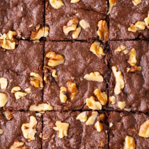 Homemade walnut brownies sliced into squares with a crackly top and super fudgy texture.