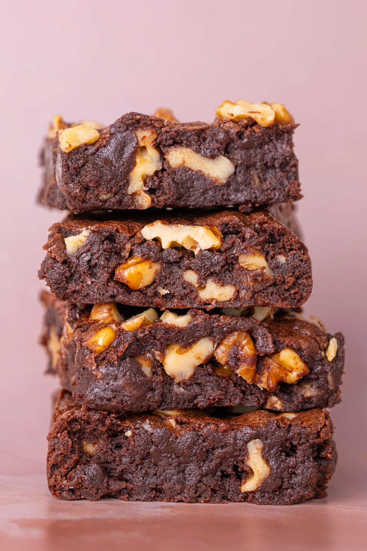 Stack of fudgy homemade brownies studded with chopped walnuts for extra flavor and texture.