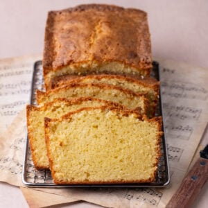 Cooling rack with sour cream pound cake sliced to show the moist texture of the cake.