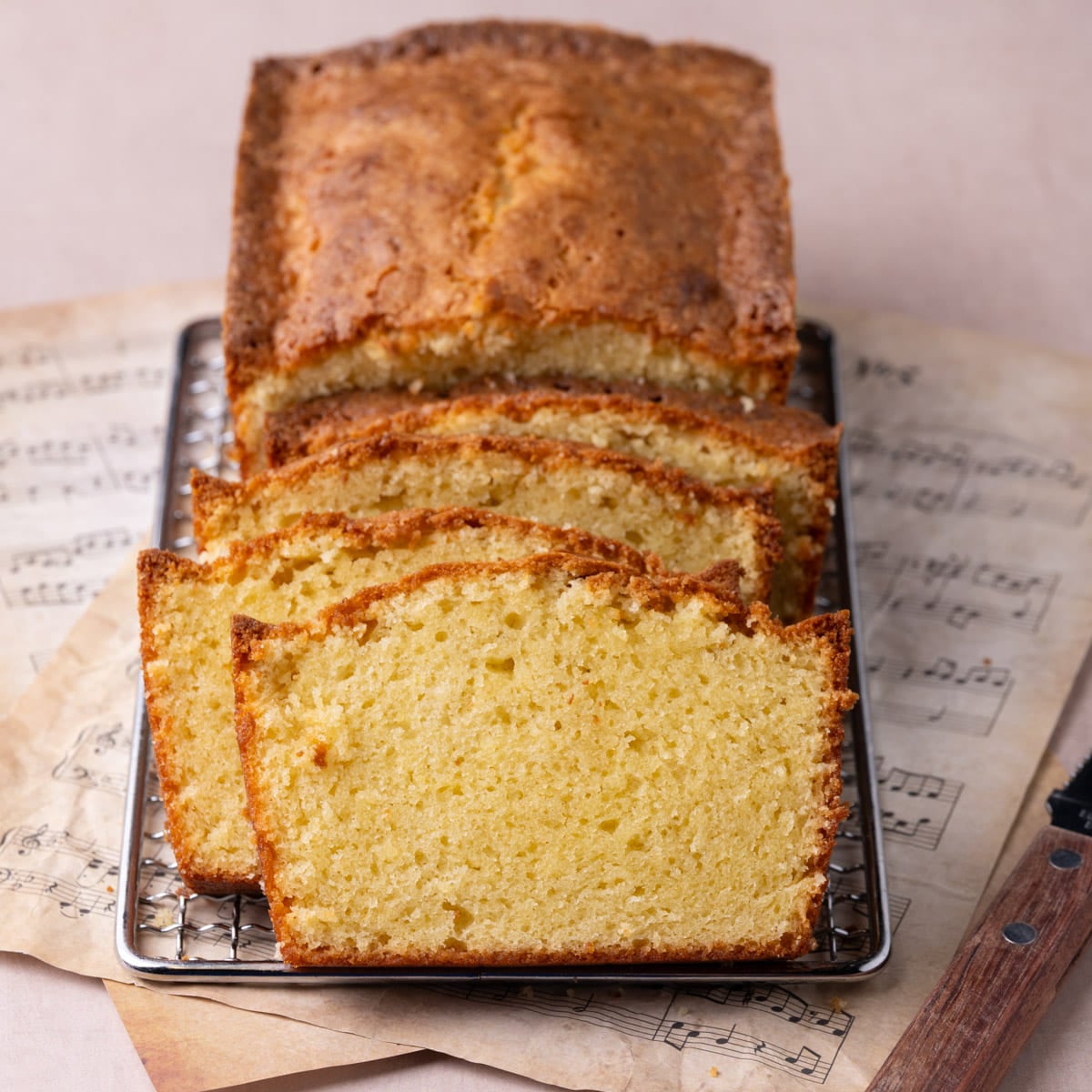 Moist Sour Cream Pound Cake Sliced on Cooling Rack Cooling rack with sour cream pound cake sliced to show the moist texture of the cake.