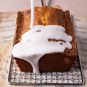 Pouring coconut icing over a pound cake to add moisture and tropical flavor.