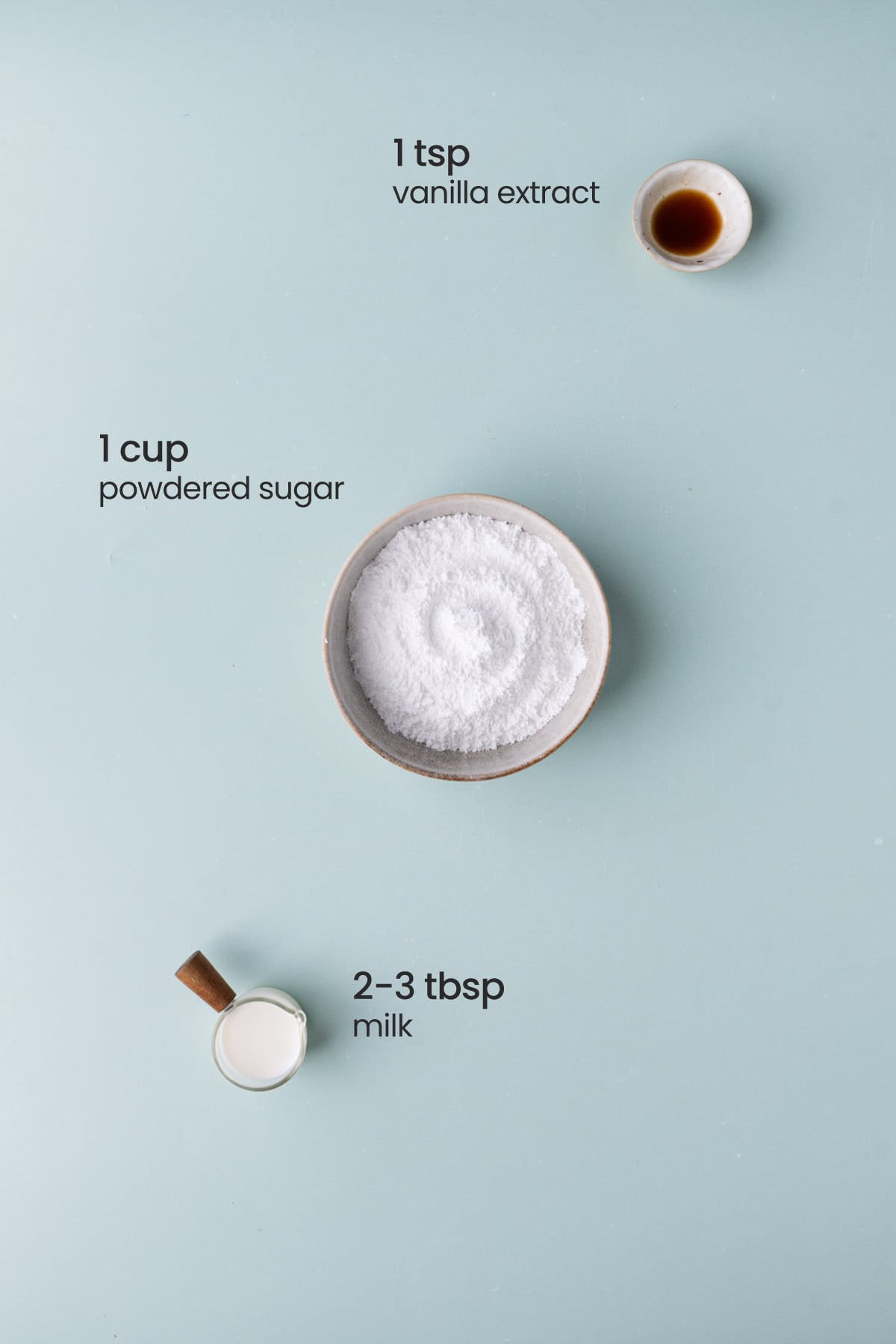 Everything you need for powdered sugar icing including vanilla extract, confectioner's sugar, and milk.