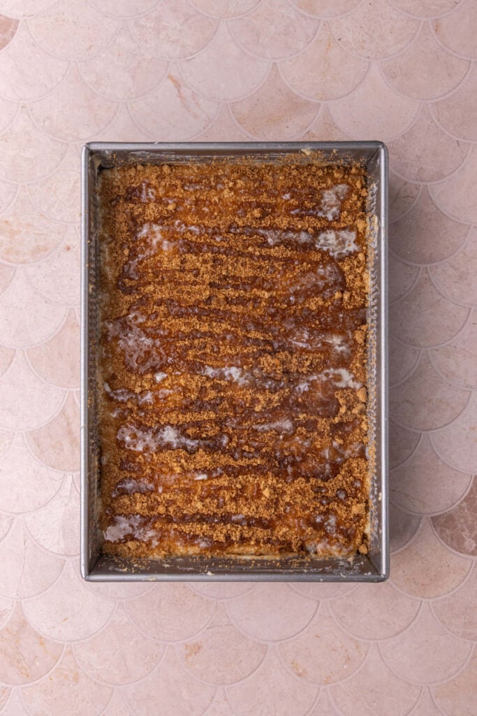 Layered coffee cake topped with cinnamon sugar and melted butter.