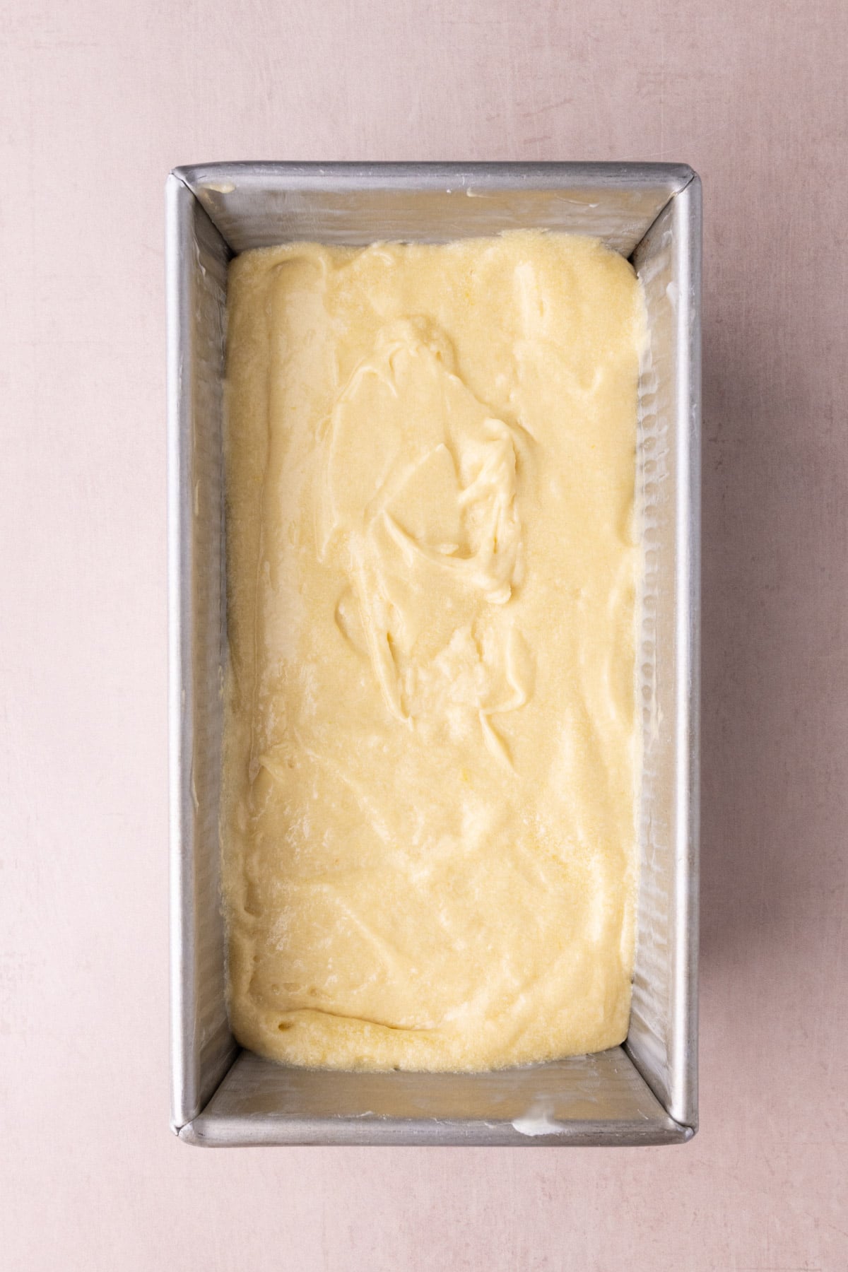 Pound cake batter with sour cream in a loaf pan ready to bake in the oven.
