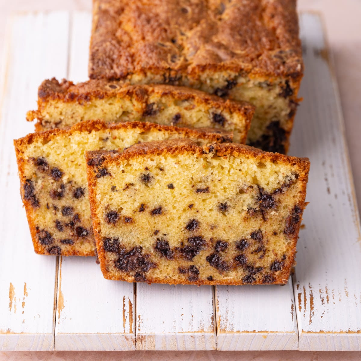 Chocolate Chip Pound Cake Sliced to Show Moist Texture Chocolate chip pound cake with sour cream sliced to reveal a moist and tender crumb with a generous amount of chocolate chips.