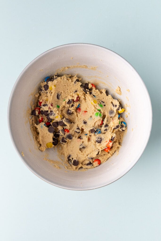 Chocolate chips and M&M's folded into cookie dough to make M&M cookie bars.