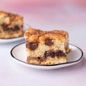 Slice of moist chocolate chip coffee cake with layers of cinnamon sugar and melty chocolate chips.