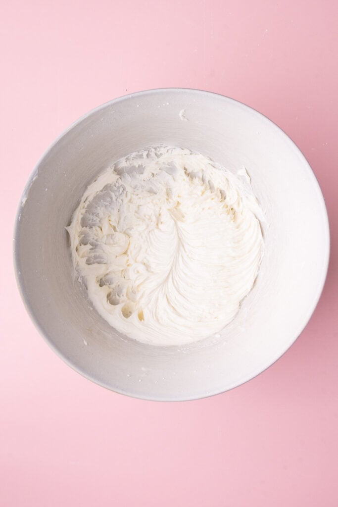 Freshly made 4-ingredient sour cream frosting in a large mixing bowl.