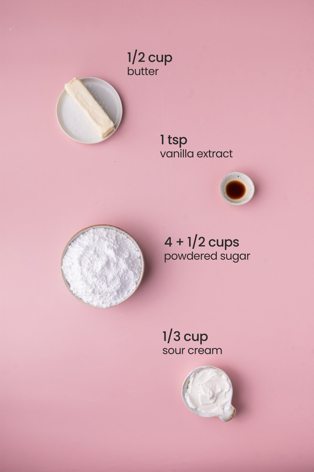 Everything you need to make Sour Cream Frosting including butter, sour cream, powdered sugar, and vanilla extract.