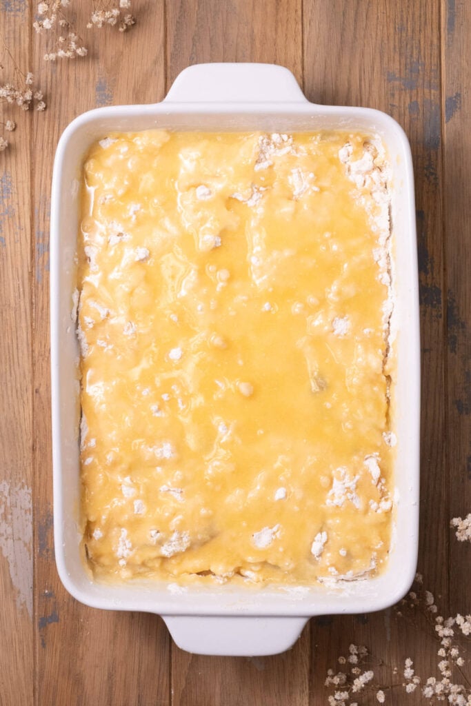 Melted butter coating box cake mix layered on top of apple pie filling.