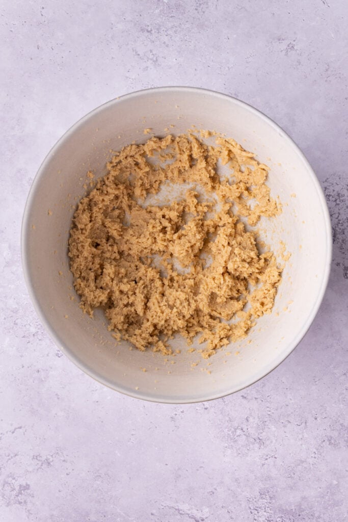Butter and brown sugar creamed together to form a light and airy base for oatmeal cookie dough.