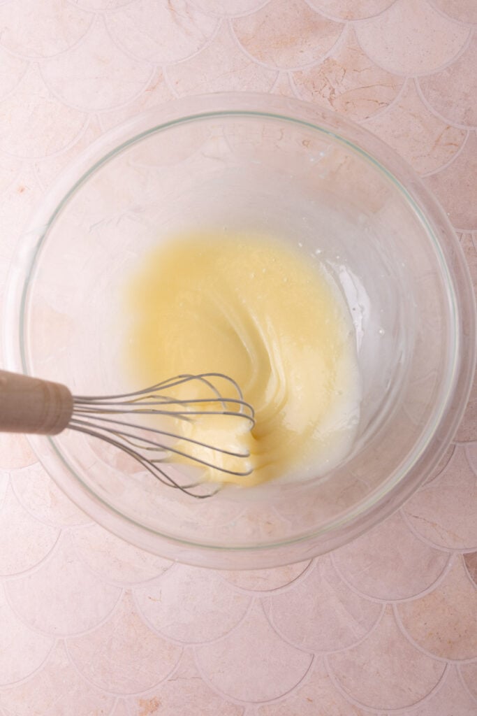 White chocolate melted and mixed into cream to make white chocolate icing.