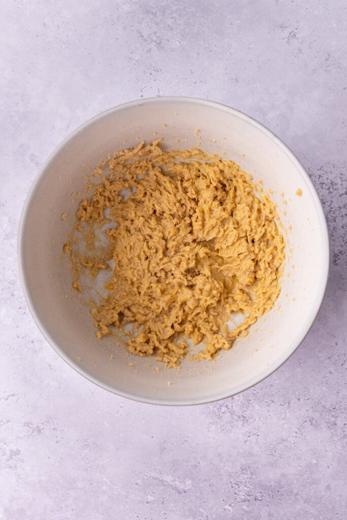 Butter, sugar, egg, and vanilla extract beat together in a large mixing bowl.