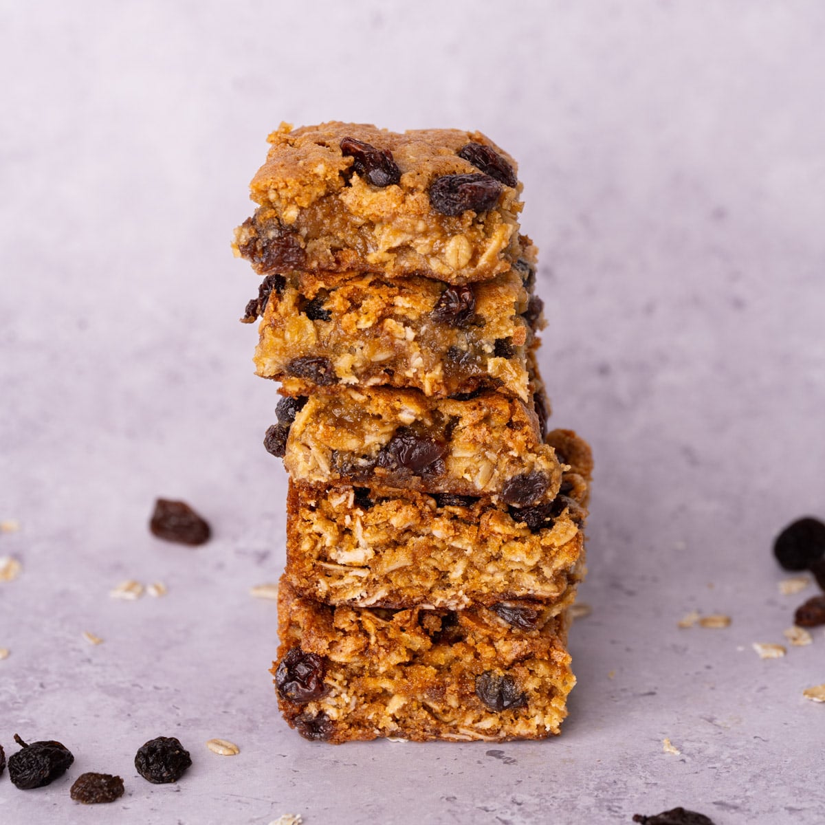 Stack of 5 freshly baked oatmeal raisin cookie bars.