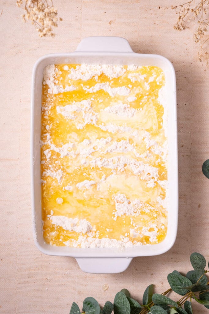 Melted butter drizzled on top of yellow cake mix and fruit filling.