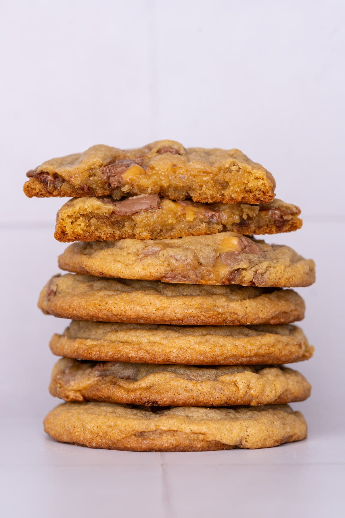 Stack of cookies with milky way bars folded into the batter.