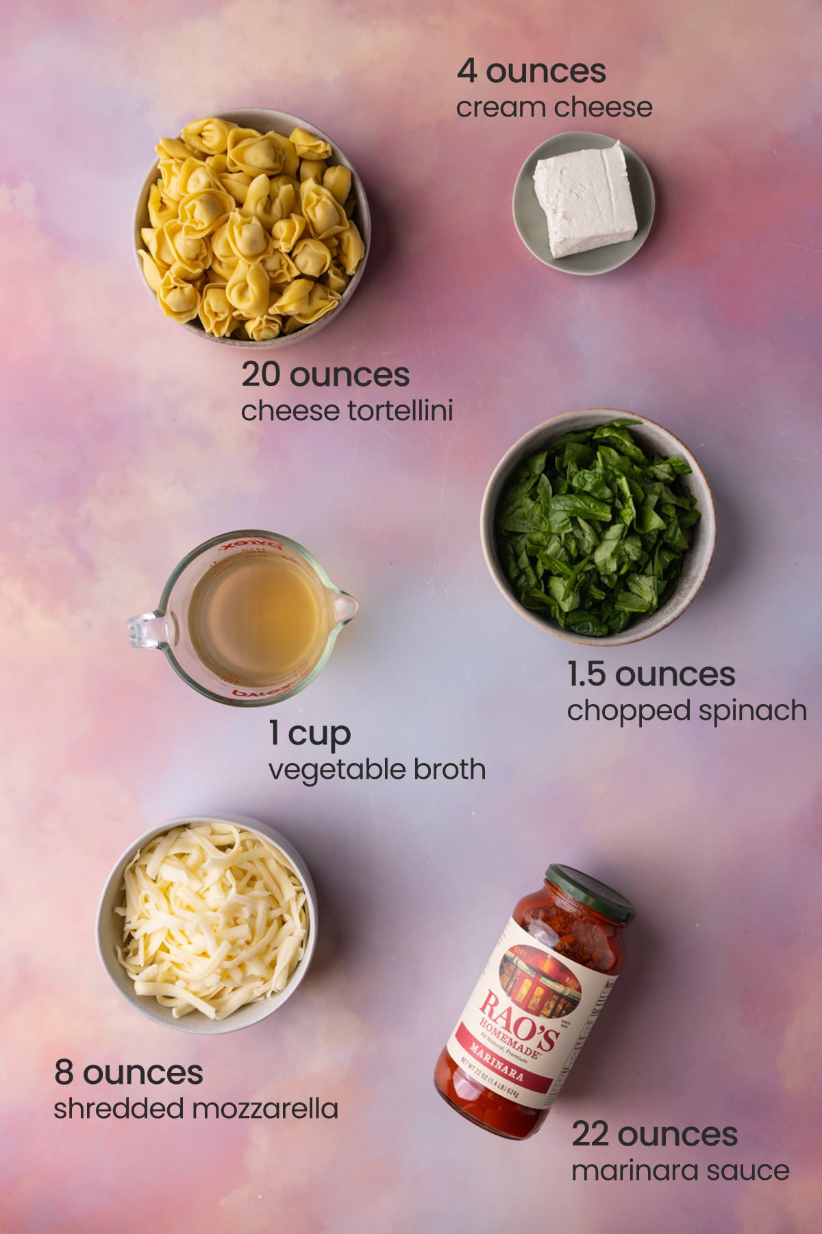 Everything you need to make a vegetarian dump and bake tortellini casserole including cream cheese, cheese tortellini, fresh spinach, vegetable broth, shredded mozzarella cheese, and marinara sauce.