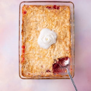 Dump and bake cake made with crushed pineapple and cherry pie filling and box cake mix.