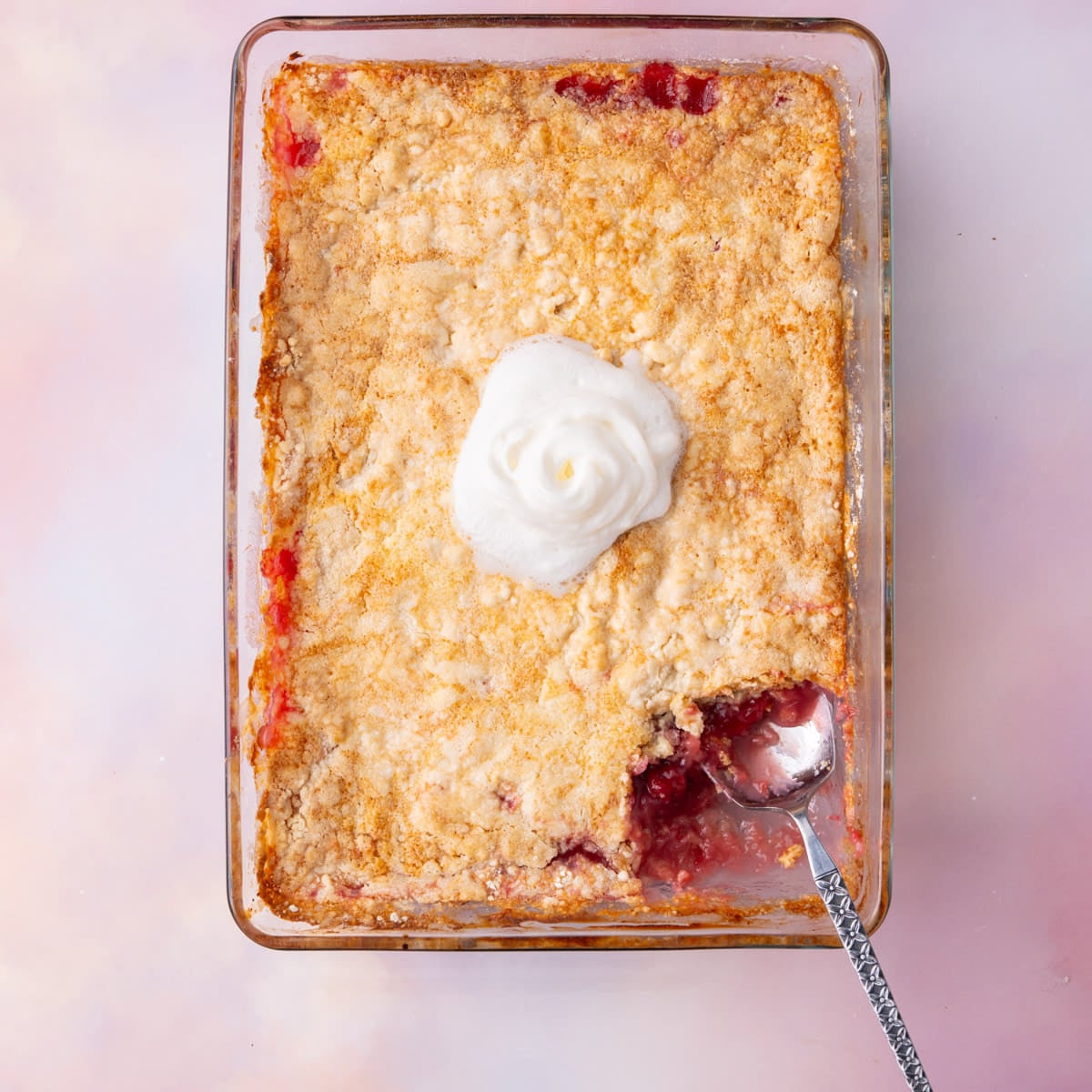 Dump and bake cake made with crushed pineapple and cherry pie filling and box cake mix.