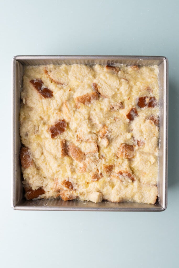 Bread pudding with crushed pineapple in a baking dish ready to bake in the oven.