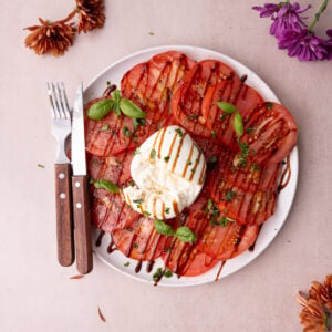 Classic caprese salad made with a ball of burrata instead of mozzarella.