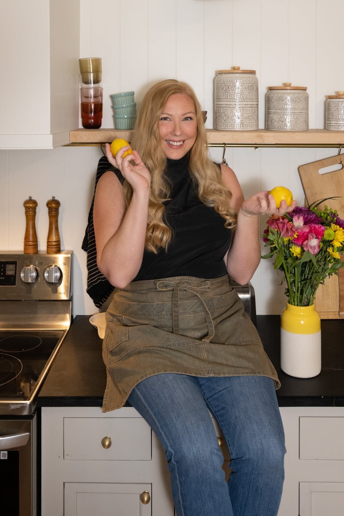 Marley Goldin of Marley's Menu on kitchen counter holding two lemons