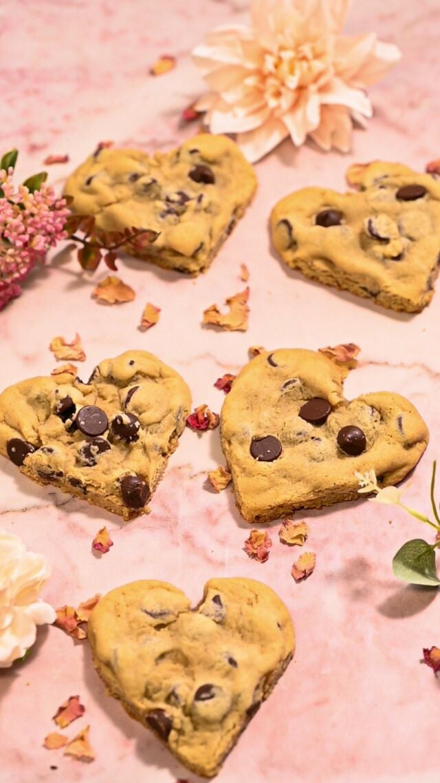 This is my absolute favorite chocolate chip cookie recipe- they’re buttery, chocolatey, and chewy with crispy edges. Plus, with a little bit of chilling time, they barely spread, making them great for shaping into hearts for Valentine’s Day! 
Ingredients
❤️	½ cup (1 stick) softened unsalted butter ❤️ 1 cup light brown sugar
❤️ 1 tablespoon vanilla extract
❤️ 1 large egg
❤️ 1 ¾ cup all-purpose flour
❤️ 1 teaspoon table salt
❤️ ½ teaspoon baking soda
❤️ 1 cup chocolate chips 
Method
❤️ To a large mixing bowl, add softened butter and brown sugar and use a hand mixer on high to cream together until light and smooth (about 2-3 minutes).
❤️ Add the vanilla extract and egg and use your hand mixer on low to combine.
❤️ Add the flour, salt, and baking soda and mix to combine, careful not to overbeat. Use a spatula to scrape any flour off the sides of the bowl and integrate it into your dough.
❤️ Add the chocolate chips and use a spatula to fold them into the dough.
❤️ Roll dough into roughly 15 equal sized cookies. Use a knife to cut a slit in the top of each cookie ball, then use two clean hands to flatten and shape them into hearts. 
❤️ Place heart shaped cookies in the freezer for 30 minutes to set. 
❤️ Preheat your oven to 350°F and bake the cookies for 10-12 minutes. While they’re still hot, use a spoon to reshape the heart where spreading occurs if necessary. Enjoy!

#chocolatechipcookies #heartshapedcookies #heartcookies #valentinecookies #romantic #bakingfromscratch