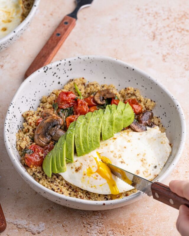 In my quinoa bowl era 🤌 This Savory Quinoa Breakfast Bowl is loaded with protein, fiber, and flavor from the eggs, sautéed veggies, and avocado. #healthybreakfast #breakfastgoals #overeasyeggs #quinoabowl #breakfastbowl #proteinbreakfast