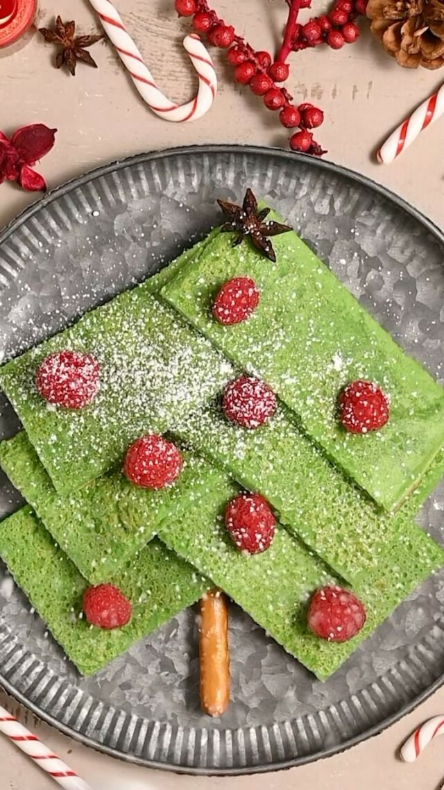 Cute Christmas breakfast idea! Listen I’m the first to admit I’m not great when it comes to the DIY themed food but this one EVERYONE can do! Start your holiday off right with this cute Christmas tree made from hidden veggie pancakes and topped with fresh fruit. 
-2 tablespoons unsalted butter (melted)
-2 cups milk (dairy or unsweetened non-dairy)
- 2 ounces (1 cup tightly packed) spinach (or green food coloring to desired color)
-2 large eggs
-2 teaspoon vanilla extract
-1 ½ cups all-purpose flour
-¼ cup light brown sugar (tightly packed)
-2 teaspoons baking powder
-½ teaspoon salt
-nonstick cooking spray (as needed)
-¼ cup maple syrup for serving
-half of a pretzel rod, raspberries, 1 star anise, and powdered sugar to decorate as Christmas tree.

-Preheat your oven to 425°F and prep a baking sheet with nonstick cooking spray of choice. For thinner, more authentic pancakes, use a 12 x 18-inch baking sheet (preferred). For thicker, fluffier pancakes, use a 13 x 9-inch baking sheet.
-In a small microwave-safe dish, microwave the butter on high for 30 seconds until completely melted. Set aside to cool.
-Add the milk and spinach to a high-powered blender and blend on high until smooth. 
In a large mixing bowl, whisk together the flour, sugar, baking powder, and salt, ensuring there are no lumps.
-Add the eggs, milk, and vanilla extract, and blend again until just combined. 
-Add  the flour, sugar, baking powder, and salt, and blend again to for a smooth and thin pancake batter. 
-Pour your batter onto your prepared baking sheet and carefully lift and tilt the pan back and forth, left and right to spread the batter around the baking sheet evenly. If you are using any optional add-ins, place those on top of your batter now.
-Bake for 15 minutes until cooked through and the edges start to bubble and turn golden brown. -Allow to cool then slice into roughly even rectangles. 
-Grab half of a pretzel rod and place it vertically in the bottom middle of your plate. Stack 6 pancakes diagonally, working upward to resemble a Christmas tree.
-Place raspberry “ornaments” on the pancake Christmas tree and top with star anise and powdered sugar “snow”. Enjoy!