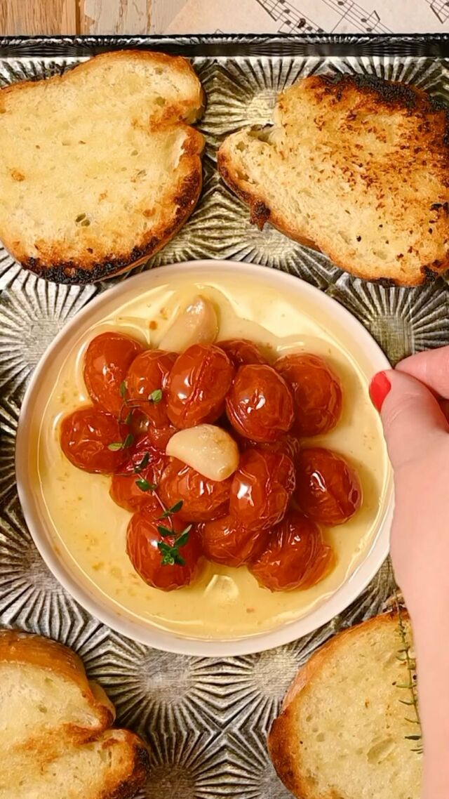 Learn how to use a simple French cooking method to preserve your fresh tomatoes and turn them into a succulent, out-of-this-world delicious, and versatile tomato confit. Only 5 ingredients required!
 -1 pint grape tomatoes
-3 cloves garlic
-½ cup extra-virgin olive oil
-1 teaspoon honey
-1 teaspoon salt
Method
-Preheat the oven to 250°F. Rinse and dry your tomatoes and peel your garlic.
-To a 1.5-quart baking dish, add the olive oil, salt, and honey and use a fork to whisk. The honey and olive oil may not readily combine, but that’s okay, just distribute it throughout the oil as best as you can.
-Add the tomatoes and garlic so that they are mostly submerged in the oil mixture.
-Place on the top rack of the oven for 1.5-2 hours until the outer skin is wrinkly, and the garlic is golden brown.
-You can opt to keep your tomatoes and garlic whole for serving, or use a fork to mash and mix the tomatoes into the oil to give you a more jam-like texture. I personally like to keep it whole! Serve on bread, tossed in pasta, in a salad, on top of baked brie, on top of fish... the options are endless! #confit #tomatoconfit #confittomatoes #grapetomatoes #garlic